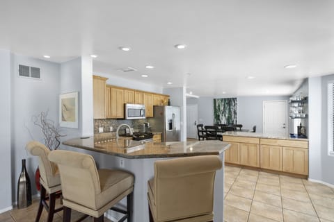 Bar into well stocked kitchen.