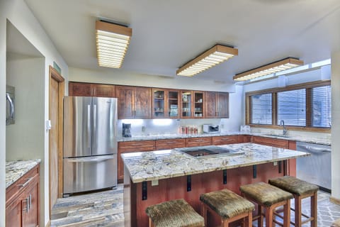 Kitchen - Beautifully upgraded space with granite counters, hardwood flooring, and stainless steel appliances.