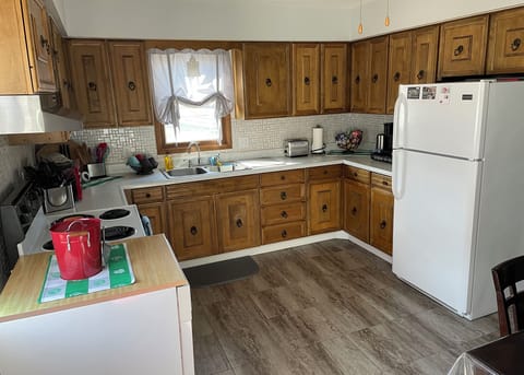 The kitchen has an electric stove/oven, refrigerator and dishwasher.