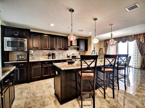 Kitchen island has breakfast bar seating for 3 guests.