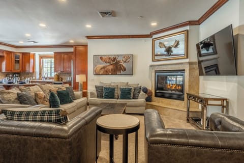 A warm, open living space anchored by a gas fireplace—designed for gathering after ski days or slow mountain mornings.