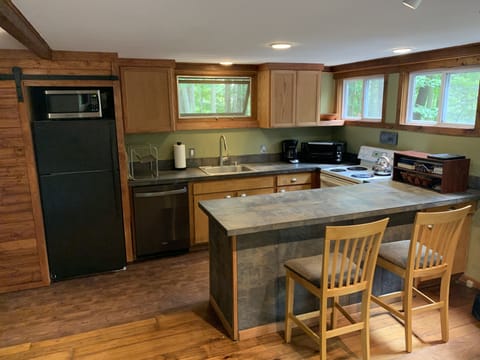 Kitchen - Laundry is hidden behind sliding barn door at left. 