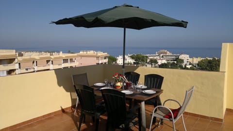 Dining at rooftop terrace, enjoying the views.