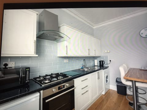Fully equipped kitchen with microwave and fridge