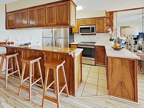 Kitchen - Enjoy serving your guests at the kitchen countertop with bar seating for three.