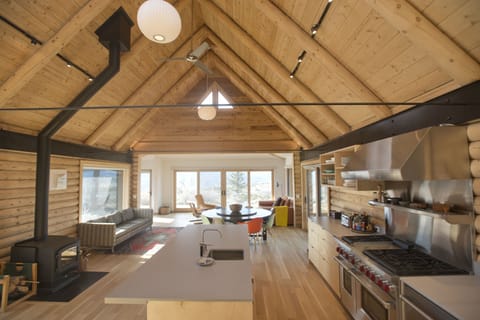 Main open plan A-frame, kitchen, dining, sitting area, wood burning stove