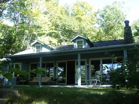 View of cottage from the lake side of property.  Covered porch.