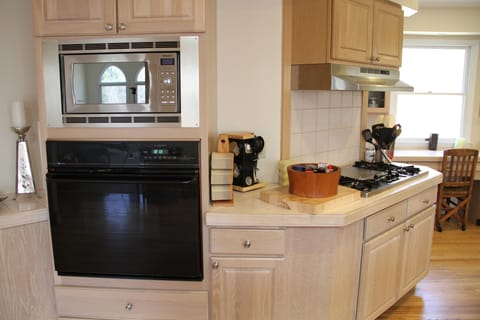 The kitchen is fully stocked with appliances, tableware, and utensils