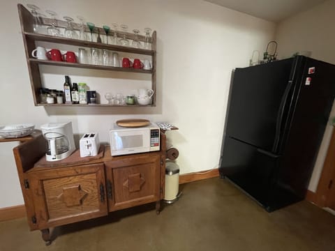 Dishes, tableware, microwave, coffeemaker, toaster and full fridge/freezer.
