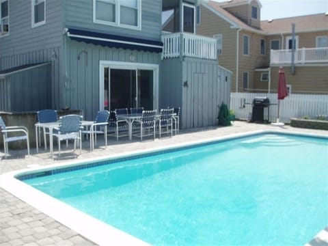 Back yard pool area, sliders lead to kitchen.  Pool is  full size, 8 ft. deep