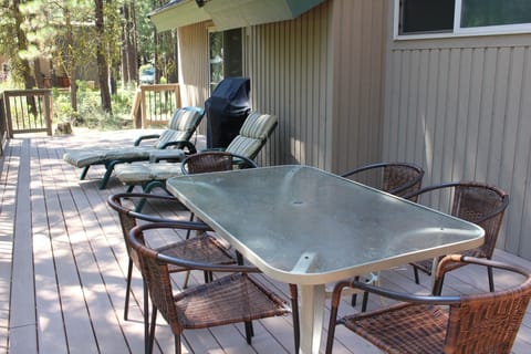 Second table, lounge chairs, and grill on back deck.