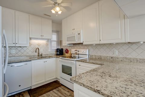 Cabinets are stocked with lots of high-end cookware leaving plenty of storage