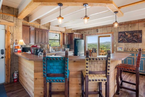 "Enjoy morning coffee at the kitchen bar, with easy access to the deck and scenic views."
