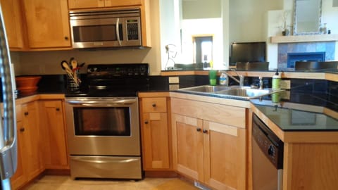 Kitchen with electric range, oven, microwave and dishwasher.