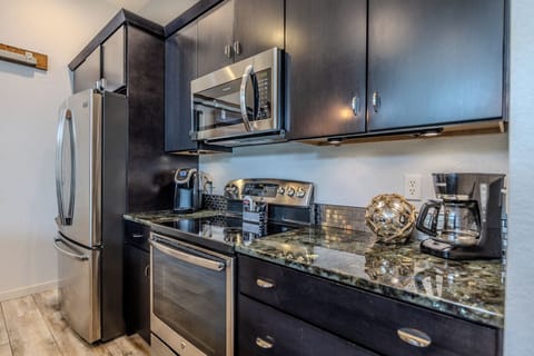 Sleek modern kitchen with stainless steel appliances, perfect for any stay.