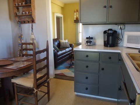 the kitchen leads into the living room, with the pull out sofa bed