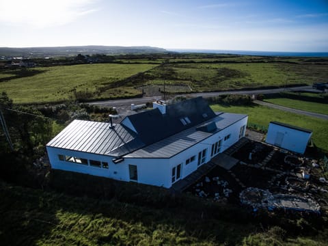 Aerial view shows original house plus additions to make this large space