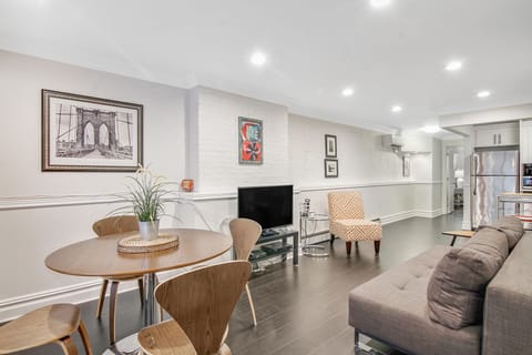 Open-concept living featuring a dining area, living room with a flat-screen TV.