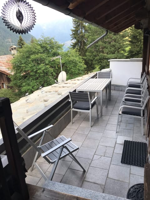 The balcony has comfortable seating with a stunning view.