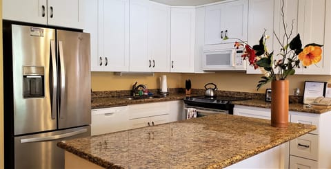 Kitchen with granite counter and new cabinets