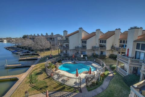 Aerial view of condo, swimming pool, and lake; X is our condo