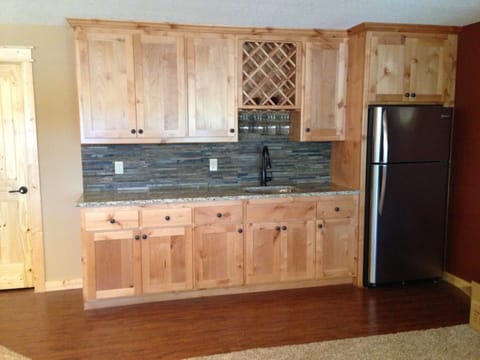 downstairs bar area with full fridge/freezer for extra storage