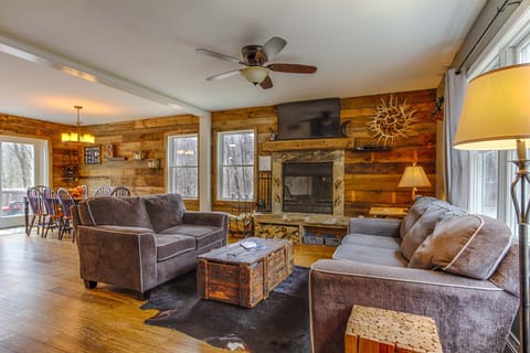 Living room with beautiful wood burning fireplace which is open to the kitchen