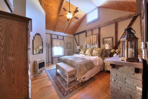 Master bedroom, king bed, flat screen TV, and fireplace. 