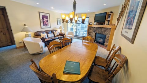 Living room with sofa bed, gas fireplace, and balcony w/ propane BBQ grill