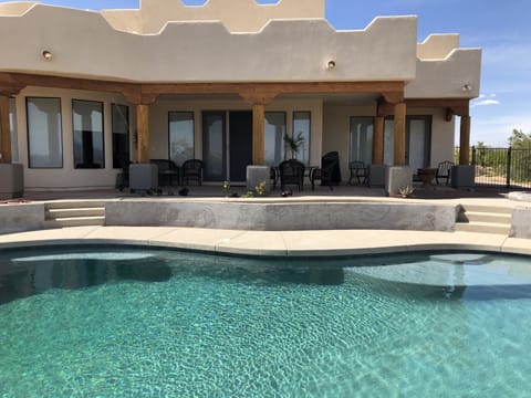 Entertaining backyard with large pool and fire pit area. 