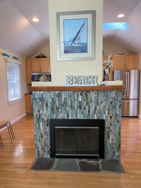 The focal point upon entry is our fireplace covered with sea glass tiles.