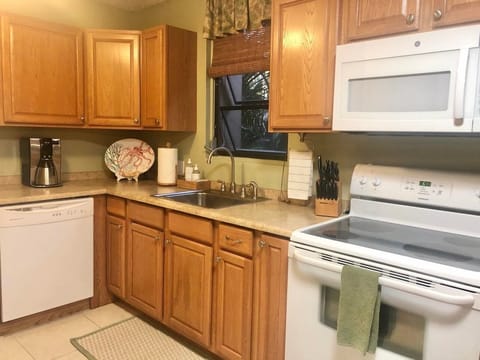 Kitchen includes dishwasher, microwave & stackable washer and dryer