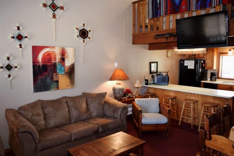 Curl up on your cozy couch or unwind at the breakfast bar in this welcoming open-concept space, where warm wood accents and unique Southwestern décor make you feel right at home.