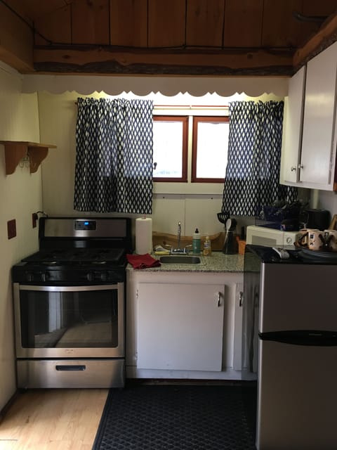 Kitchen; 7.4 cubic ft fridge; gas stove and oven, dishes and cutlery, pots&pans