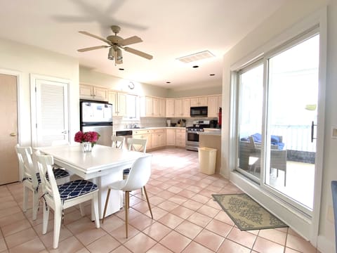 Full kitchen #1 leads to a covered porch-- watch the sunset over the bay.