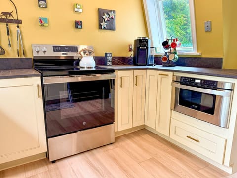 Kitchen has electric stove and microwave drawer