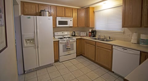 LARGE KITCHEN WITH DOUBLE DOOR REFRIGERATOR, DISHWASHER, AND FULLY STOCKED.