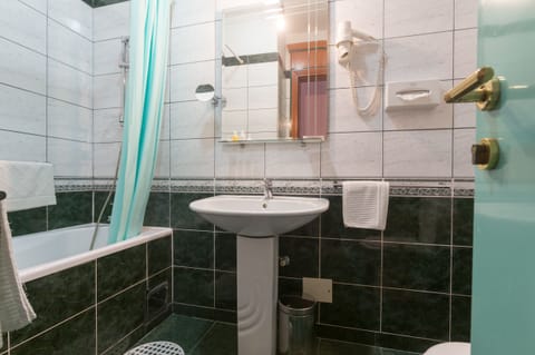 Private Bathroom Contains a Bath. Linens, Towels and Free Toiletries are There.