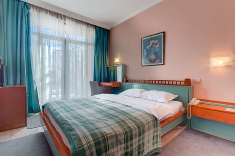 Queen-Size Bed is in the Room, as Well as Flat Screen TV with Cable Channels. 