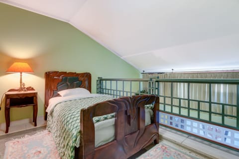 Night Stand, a Lamp and a Mirror are Also in the Bedroom.