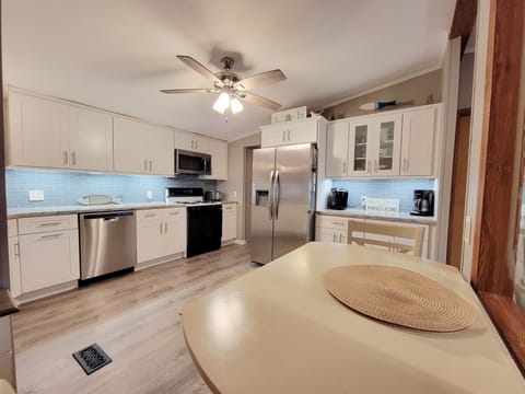 Coffee bar plus cabinets with seasonings and basic pantry items.