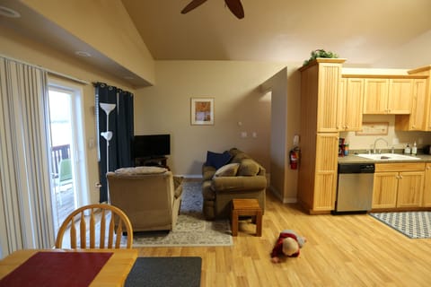 Living room with TV, couch that sleeps one, and lazy boy chair