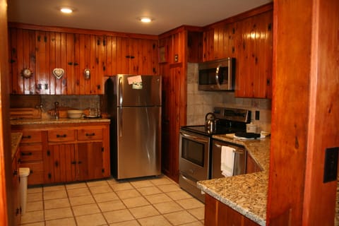 kitchen has been updated with granite counters and stainless steel appliances