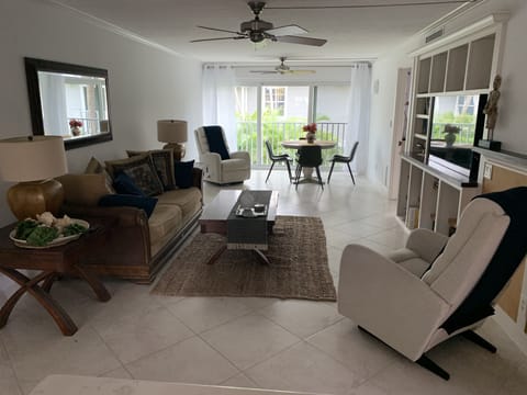 Living room with 2 Lazy Boy rockers , sliding stacking doors to open the room . 