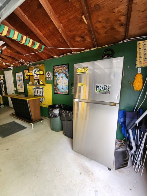 Authentic 1950's Wisconsin bar and large refrigerator in the garage rec room
