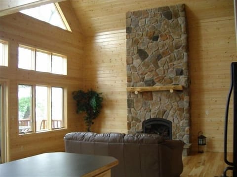 16 ft stone fireplace in great room with hardwood floors
