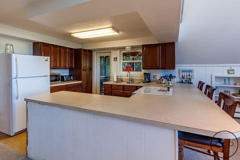 Kitchen with added seating at the counter. This is a great remote workspace.
