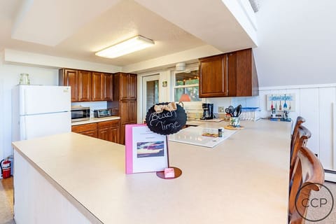 Kitchen with doorway to a deck for extended living space. 