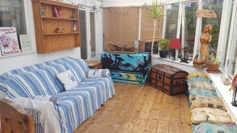 The sunny conservatory with sea and garden views.