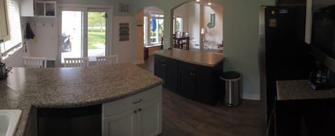 Kitchen view into family room and back slider out to deck 